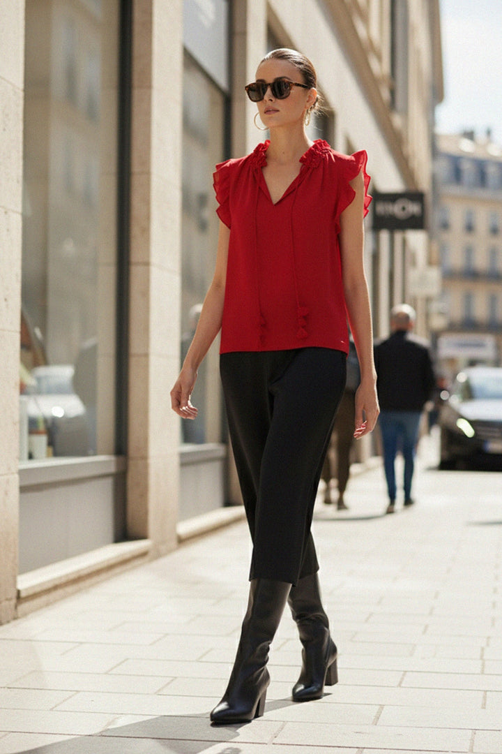 Shahida Parides, Side Pose, Designer Red Top, Ruffle Blouse, Sleeveless Top, Luxury Womenswear, Street Style, Modern Chic, Elegant Look, Urban Fashion, Red Fashion Top, Contemporary Outfit