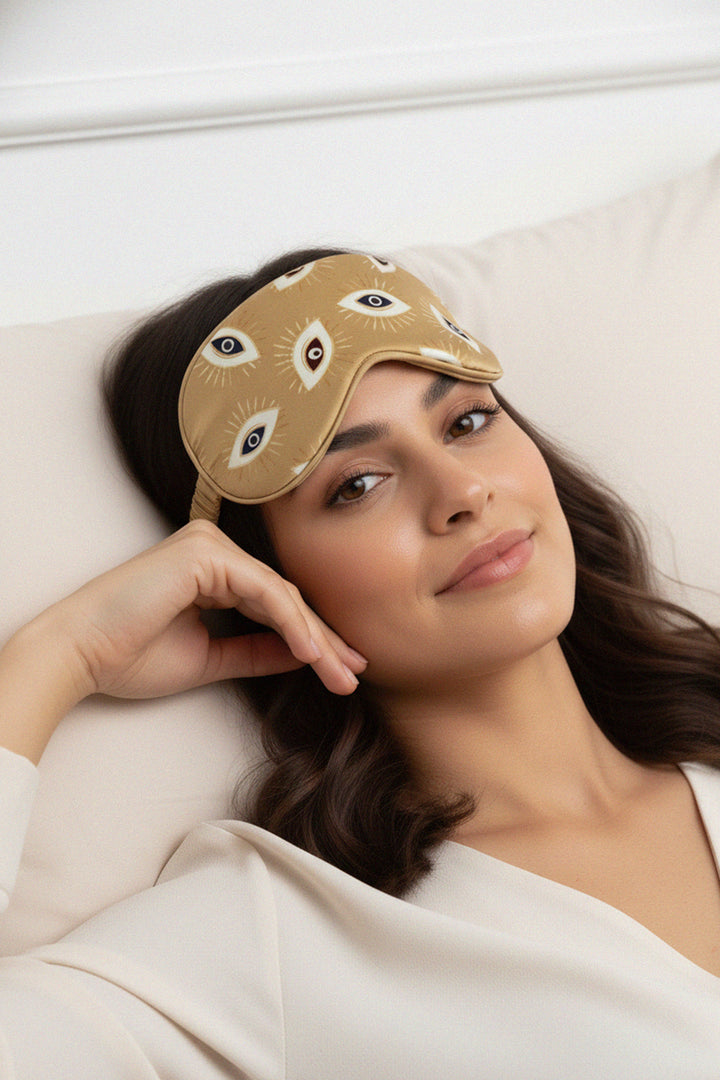 gold sleep mask, spiritual design, artistic sleepwear, calm bedtime mood, high-end accessory