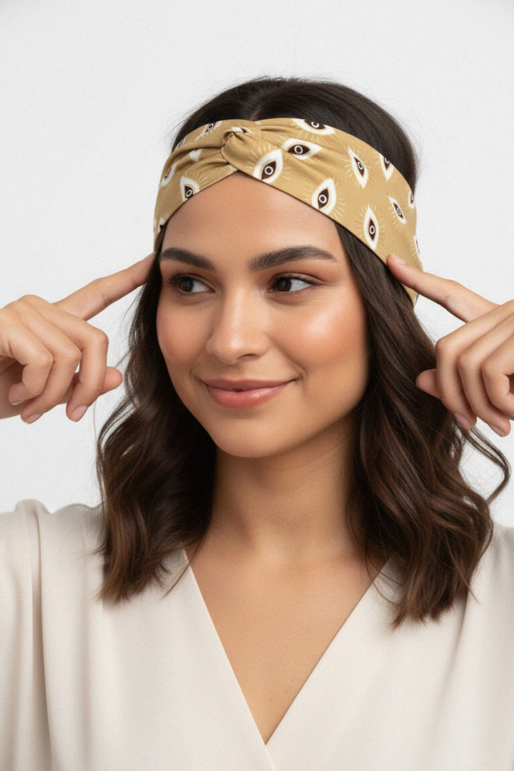 designer hairband, neutral tones, eye motif, soft wrap, fashion accessory, boho chic
